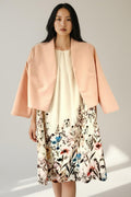 Sleeveless dress with pink jacket